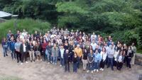 Group photo of attendees standing together outdoors during a retreat.