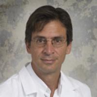 A formal portrait of a man in a lab coat